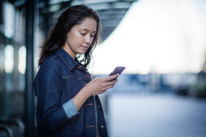 Young adult waiting on station platform