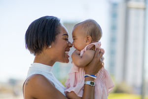Mum and new baby in city