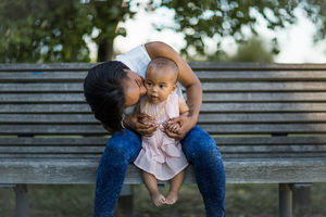 Mum kissing baby girl