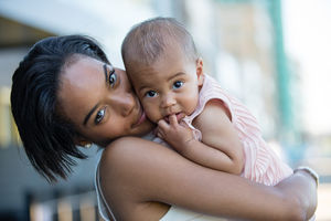 Mum and new baby in city