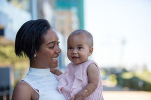 Mum and new baby in city