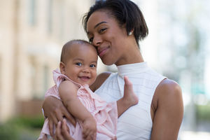 Mum and new baby in city