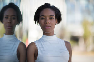 Businesswoman on way to work in city with reflections