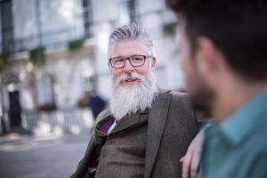 Senior talking with friend on bench