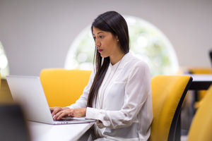 Businesswoman concentrating on laptop screen