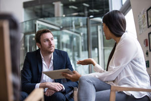 Business meeting in office atrium reception
