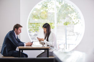 Colleagues using smartphone in an office