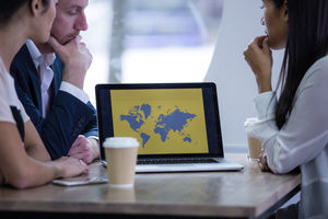 Colleagues looking at a presentation on laptop