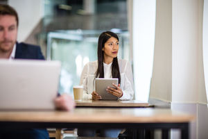 Businesswoman in a café looking out of window