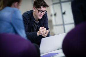 Student writing a note at college