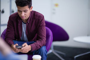 Student using smartphone at college
