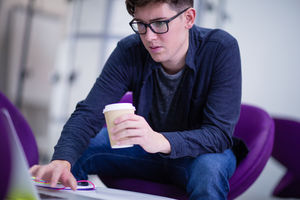 Student working on a laptop at college