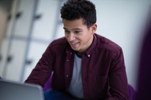Student working on a laptop at college