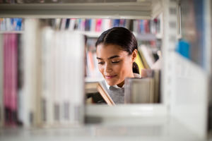 Student reading a book in library