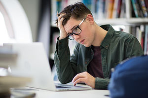 Student working on laptop in library