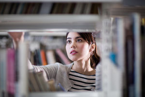 Student looking for a book in library