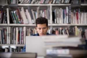 Student working on laptop in library
