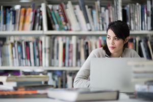 Student using laptop in library
