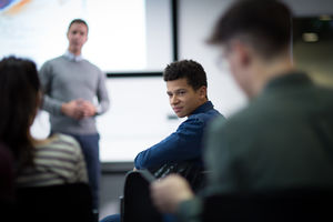 Student listening to a question at a lecture