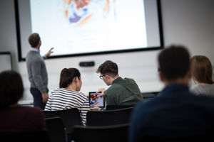 Students using digital tablet at a lecture