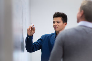 Student at a whiteboard with pen