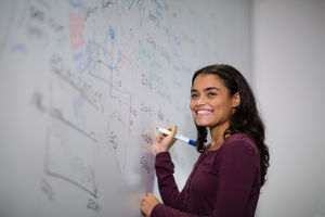 Student at a whiteboard with pen