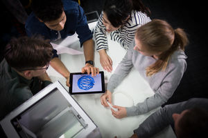 Group of students looking at design for 3D printer