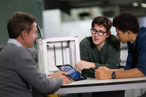 Students looking at a design for 3D model