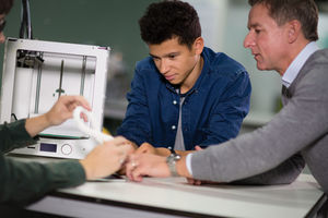 Students looking at a design for 3D model