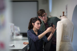 Fashion students taking a photo of a design