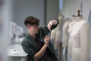 Fashion student taking a photo of a design
