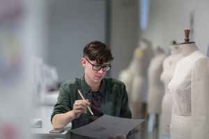 Fashion student drawing a design