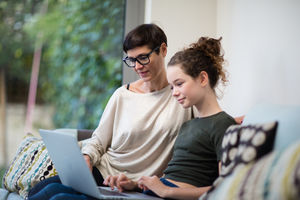 Mum checking teenage daughters homework