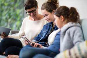 Family together looking at smartphone