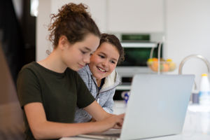 Sisters using laptop together