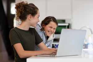 Sisters using laptop together