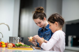 Sisters cooking a meal together