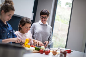 Mum teaching daughters a recipe 