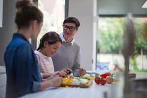Mum teaching daughters a recipe 