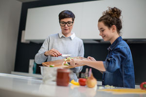 Mum and teenage daughter cooking together