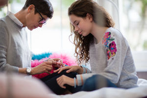 Mum painting daughters nails