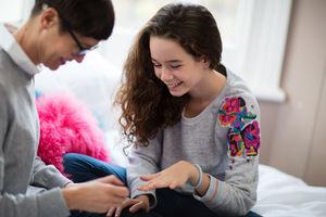 Mum painting daughters nails