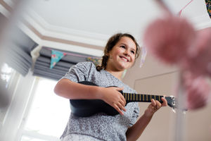 Girl playing a ukulele