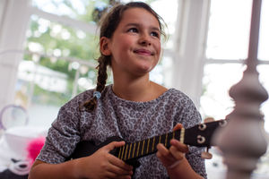 Girl playing a ukulele