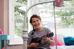 Girl playing a ukulele