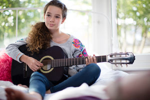 Teenager playing acoustic guitar
