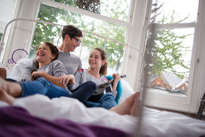 Mum with daughters playing ukulele