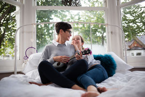 Mum with daughter playing ukulele