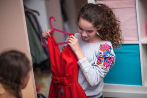 Sisters picking a dress to wear