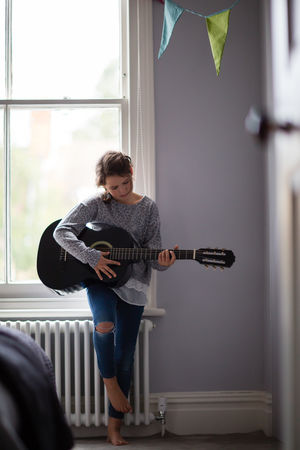 Girl playing a ukulele